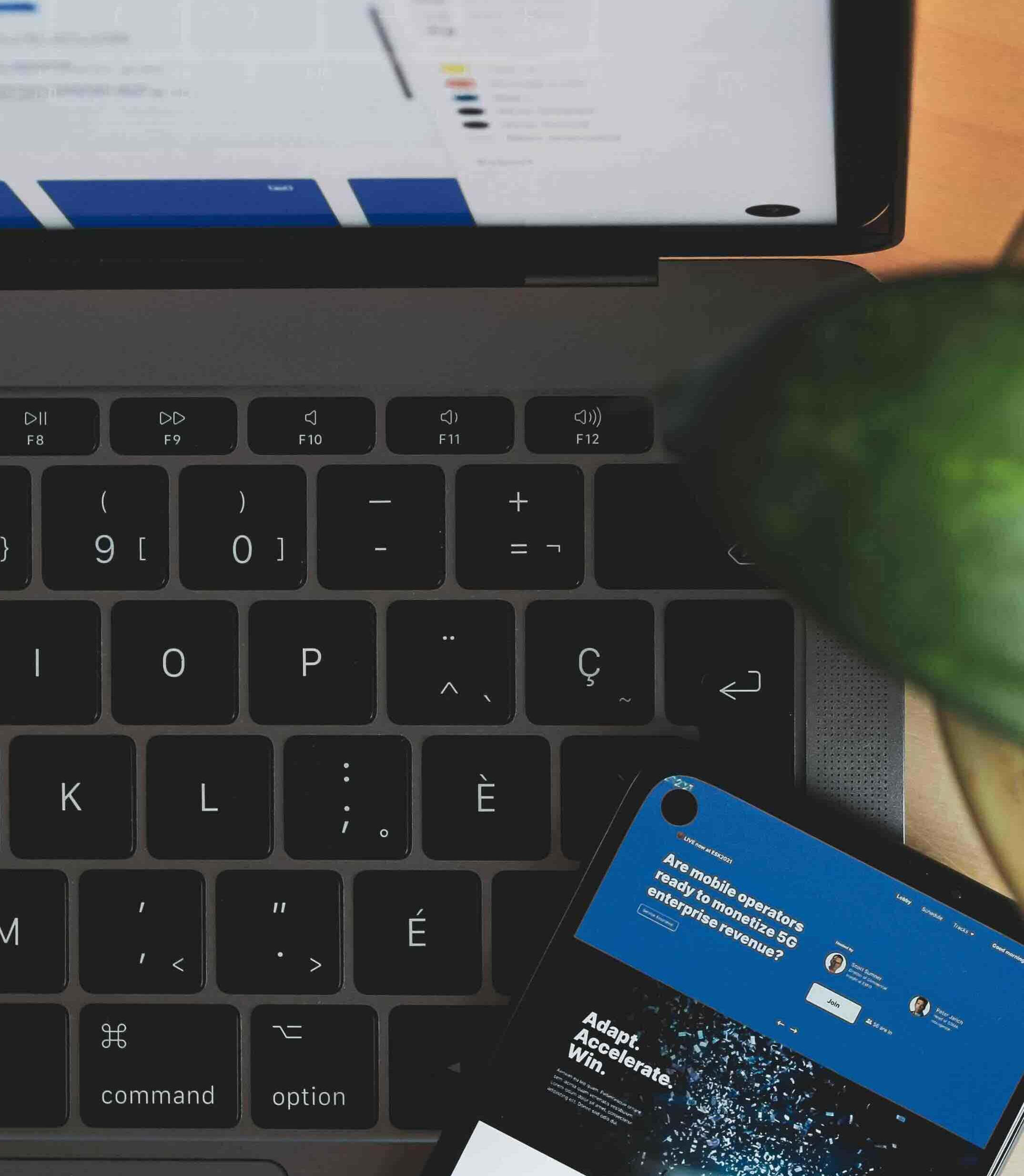 An image of a computer and a phone with a business document open on both of them.